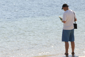 scillyman reading book in water