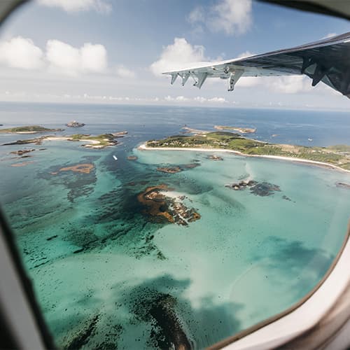 view of Tean and St Martin's out of a Skybus Twin otter window