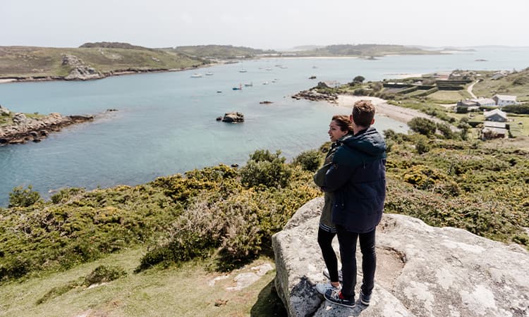 Couple admiring the view from Watch Hill, Bryher, Isles of Scilly