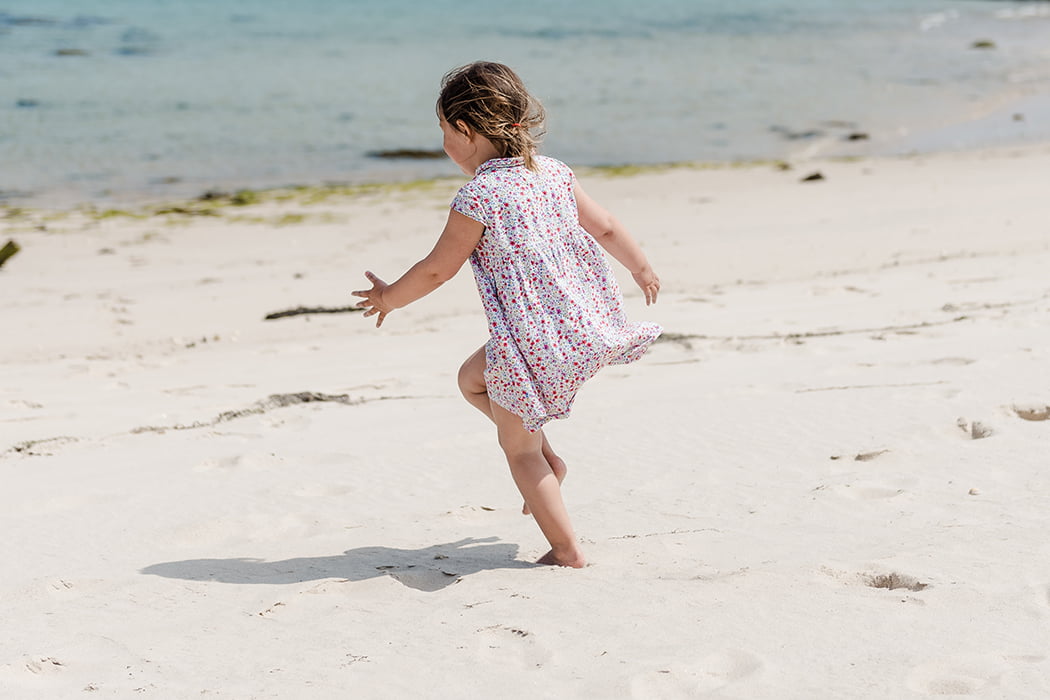 Child playing on the beach, Isles of Scilly