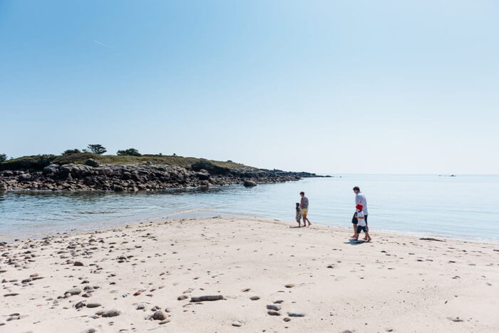 Family of four walking on the beach, Tolls Island, Pelistry, St Mary's, Isles of Scilly