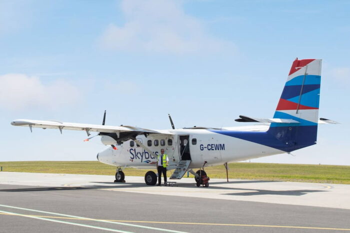 Pilot standing in front of a Skybus Twin Otter Aircraft