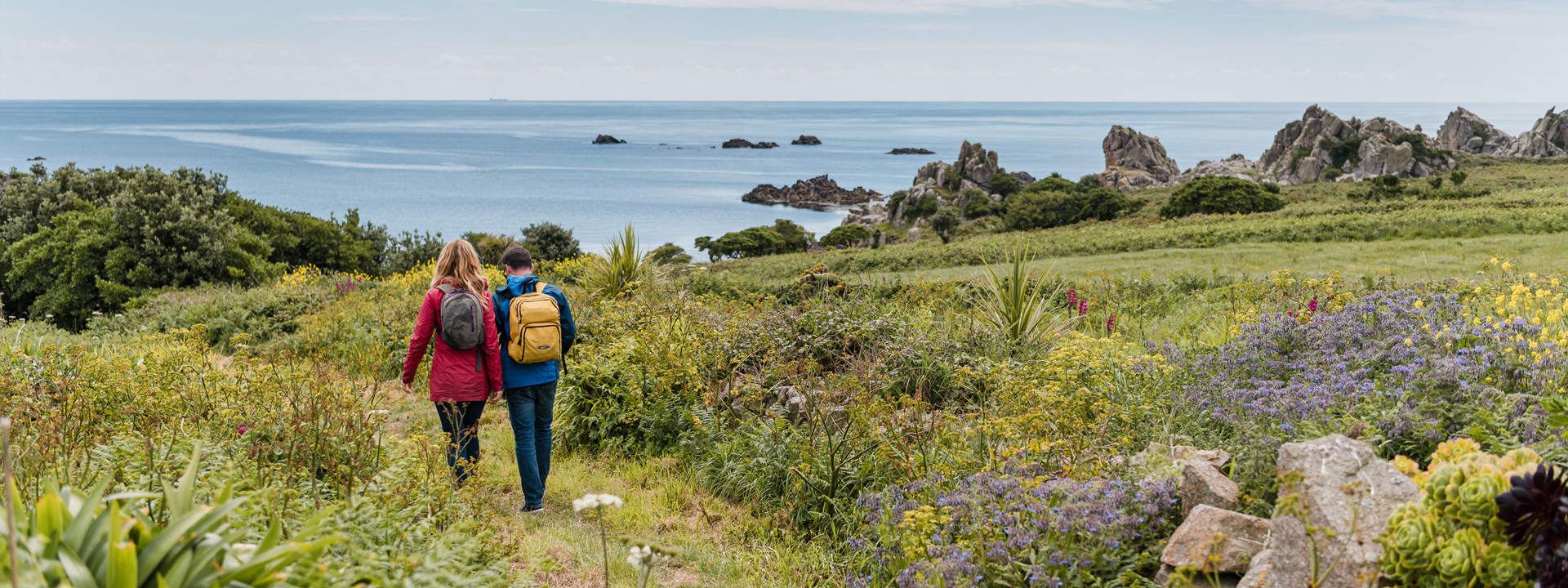 Couple walking on St Agnes, Isles of Scilly in Spring