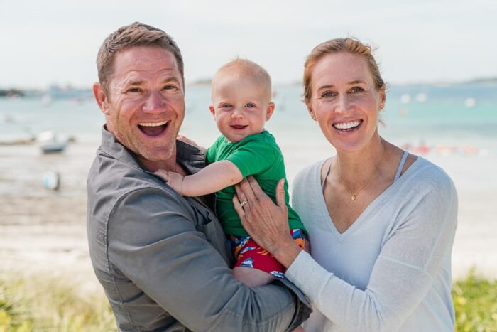Family photo of Steve Backshall, Helen Glover and their son on the Isles of Scilly