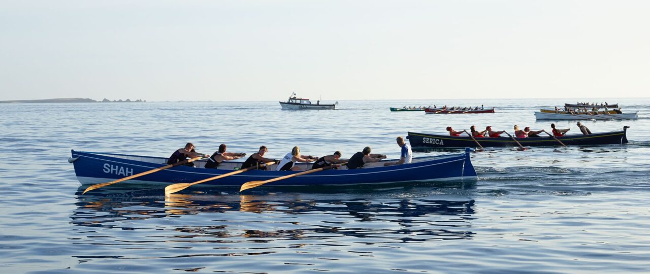 several pilot gig boats racing against each other on the Isles of Scilly