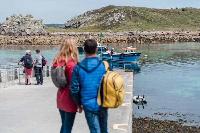 couple on the quay at St Agnes waiting for the tripper boat, Isles of Scilly