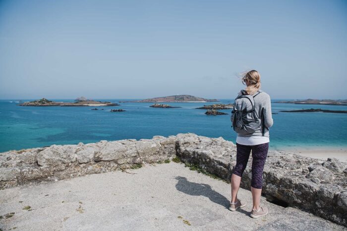 Woman standing looking at the view from The Block House, Tresco, Isles of Scilly