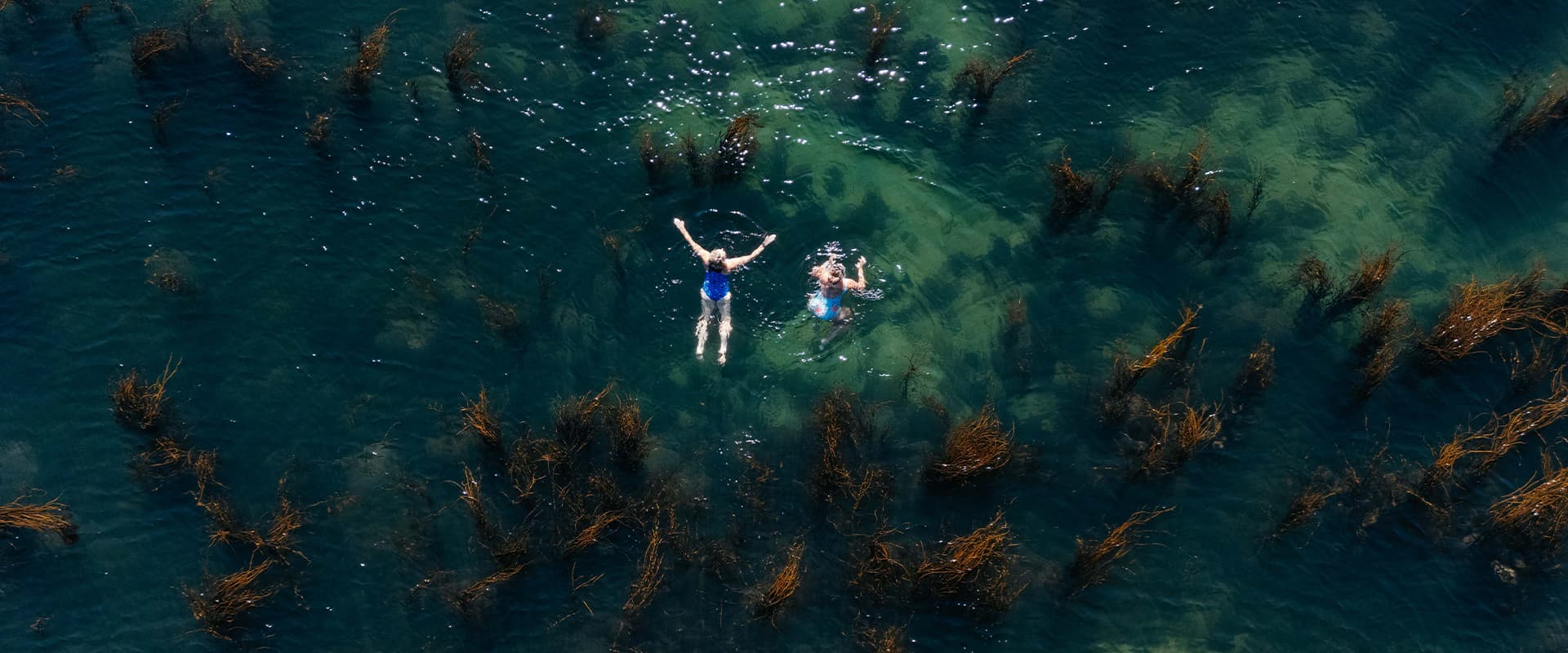 Two women wild swimming, St Mary's, Isles of Scilly