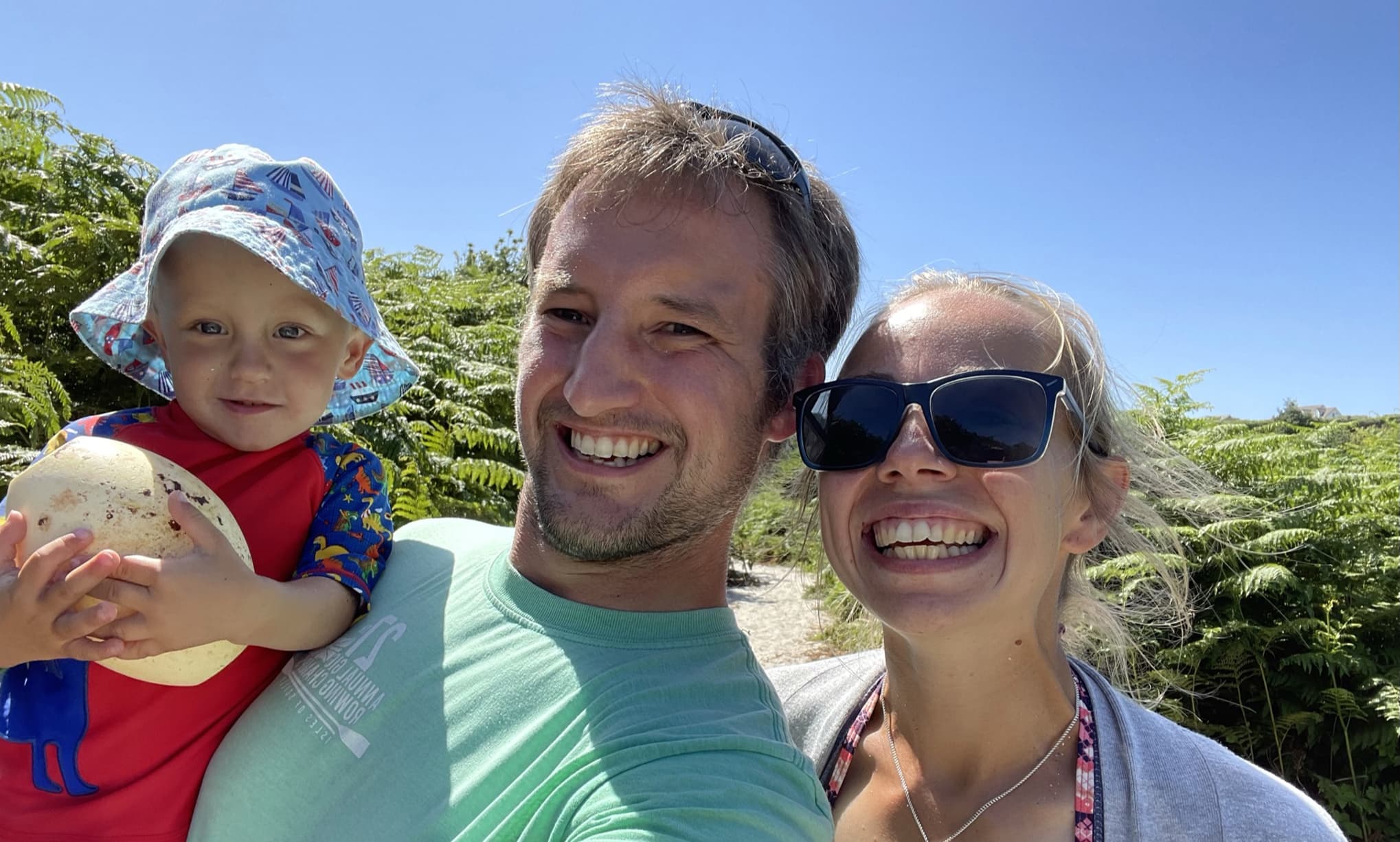 Parents with their toddler on a sunny day