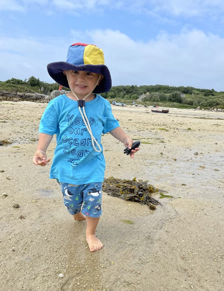 toddler walking on a beach