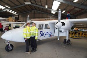 Leah and Lauren stood infront of Skybus Twin Otter
