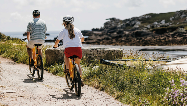 Bike Hire - A couple cycling around Old Town, St Mary's on the Isles of Scilly