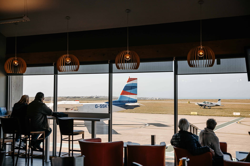 passengers in western rocks cafe at Land's End Airport, Cornwall