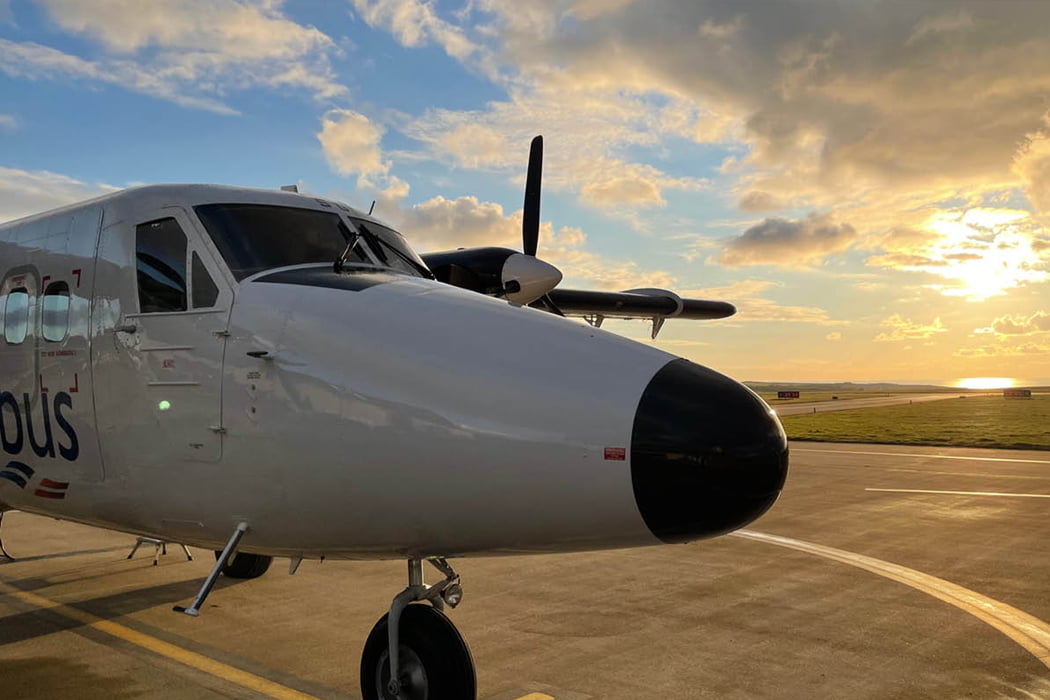 Skybus Twin Otter on the airfield in the evening sunlight