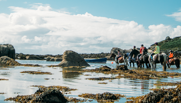 Horse riding across Pelistry Bay, St Mary's, Isles of Scilly