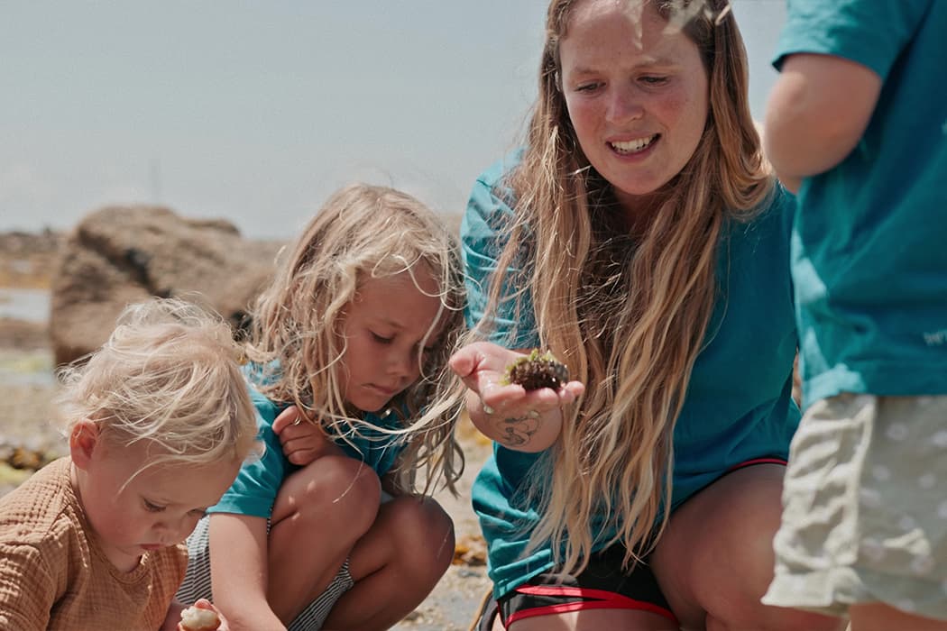 Family looking for wildlife in a rockpool, St Mary's