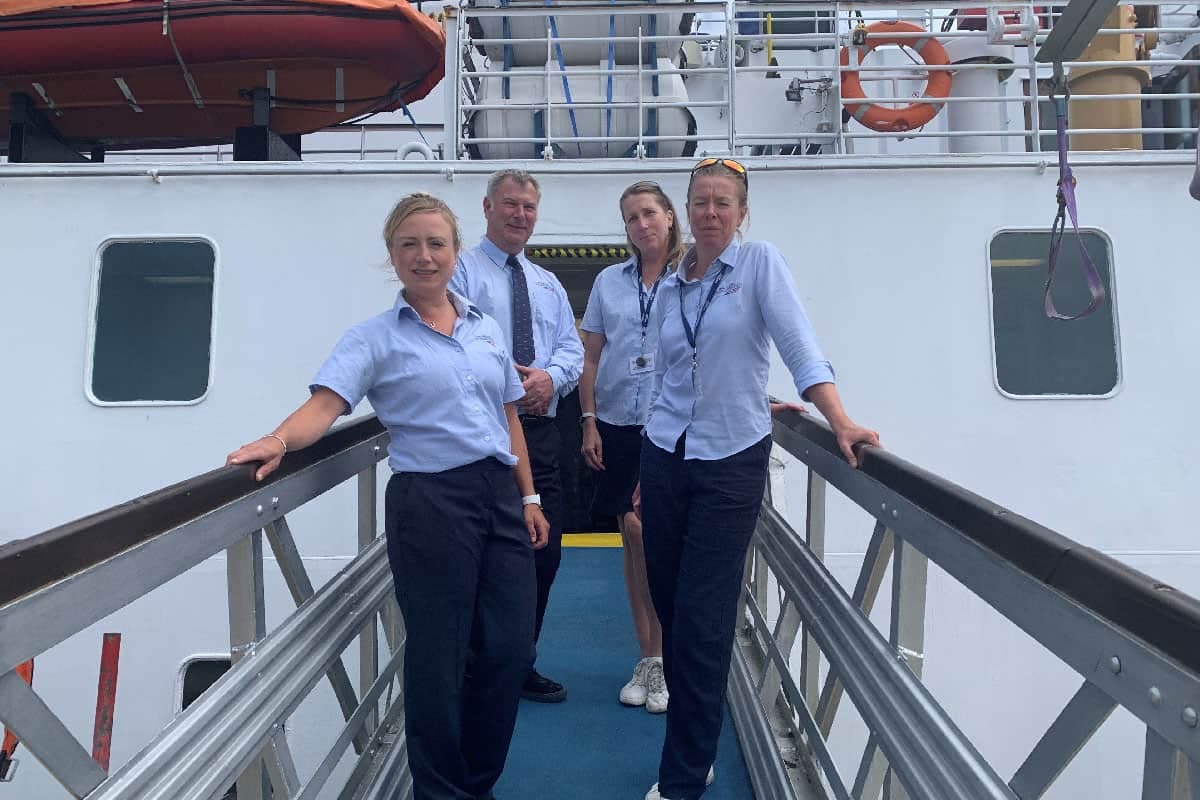 St Mary's passenger relation team standing on Scillonian III's gangway - Isles of Scilly Travel