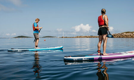 Couple paddleboarding - Porthmellon, St Mary's, Isles of Scilly