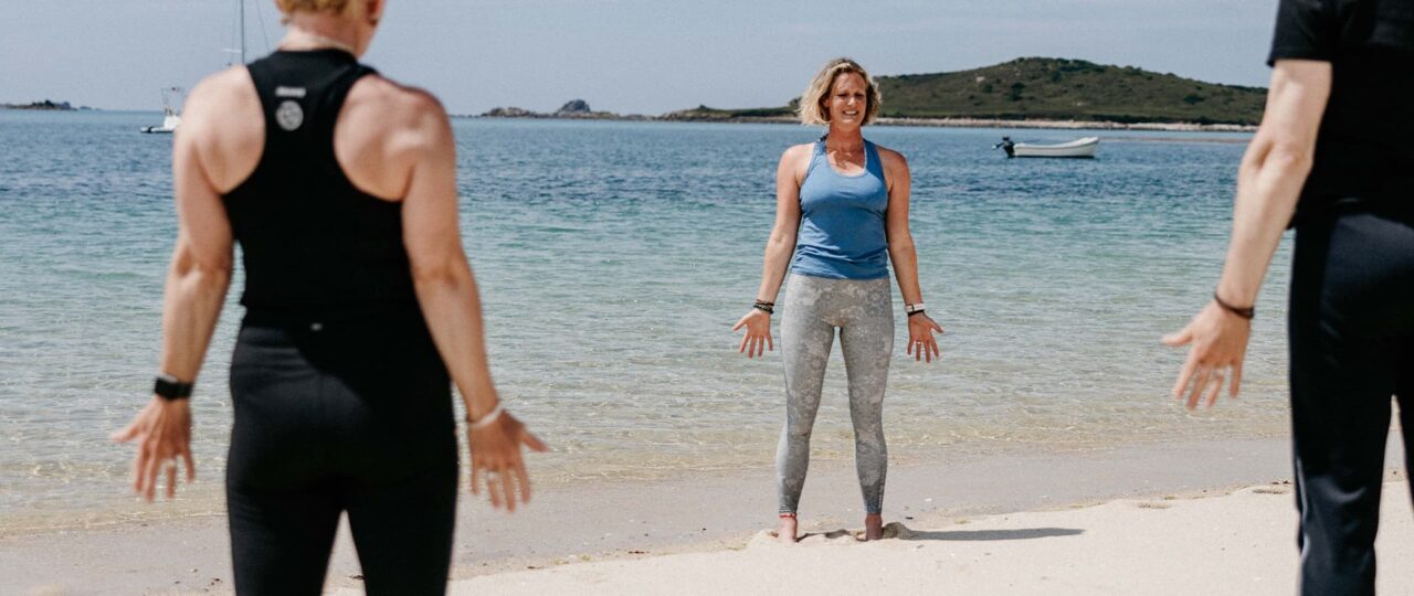 Beach yoga session on Apple Tree Bay beach, Tresco, Isles of Scilly