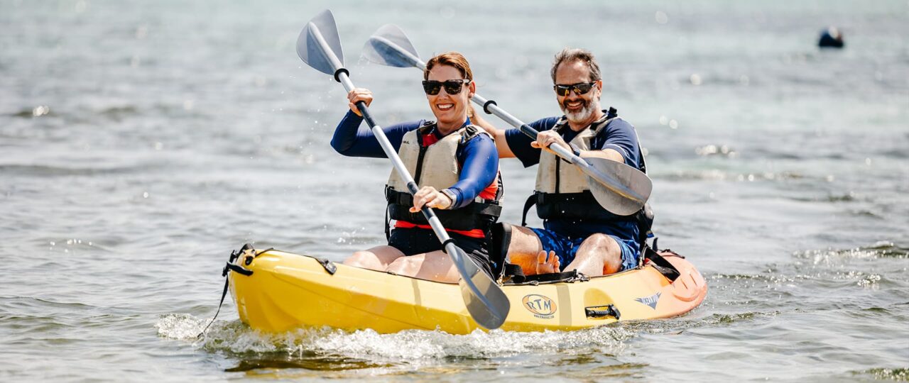 Couple kayaking along Par Beach, St Martin's Isles of Scilly