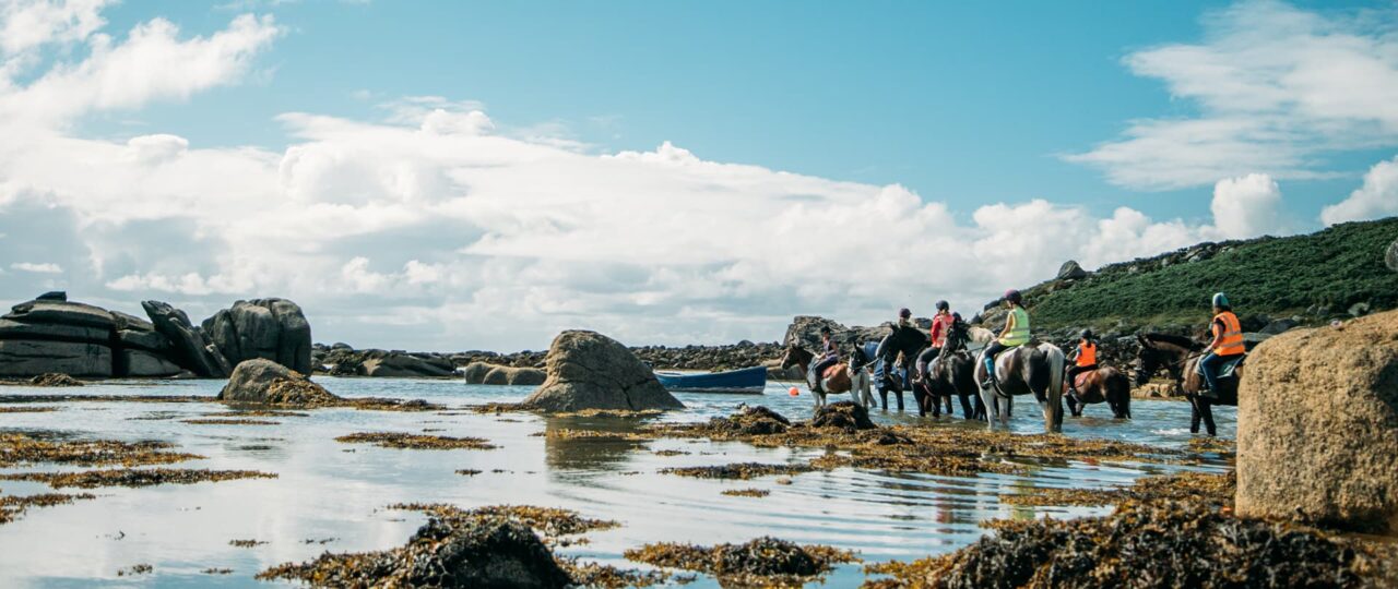 A group of riders taking horses into the sea, St Mary's, Isles of Scilly
