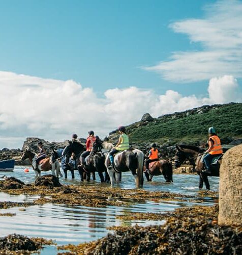 Riders taking horses into the sea, St Mary's, Isles of Scilly