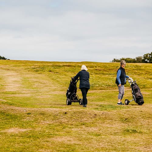 People playing golf on St Mar's golf course, Isles of Scilly