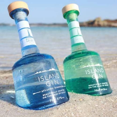 Scilly Spirit, Island Gin bottles on a beach by the sea