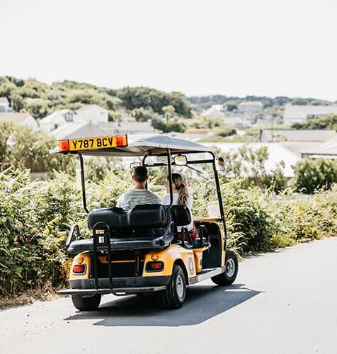 Couple in a scilly cart exploring st mary's, Isles of Scilly