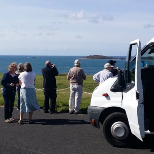 People on an Island Rover mini bus tour, St Mary's Isles of Scilly