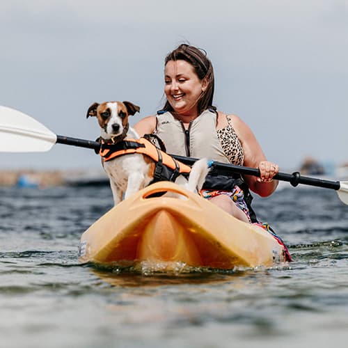 woman and dog kayaking - St Agnes Watersports, Isles of Scilly