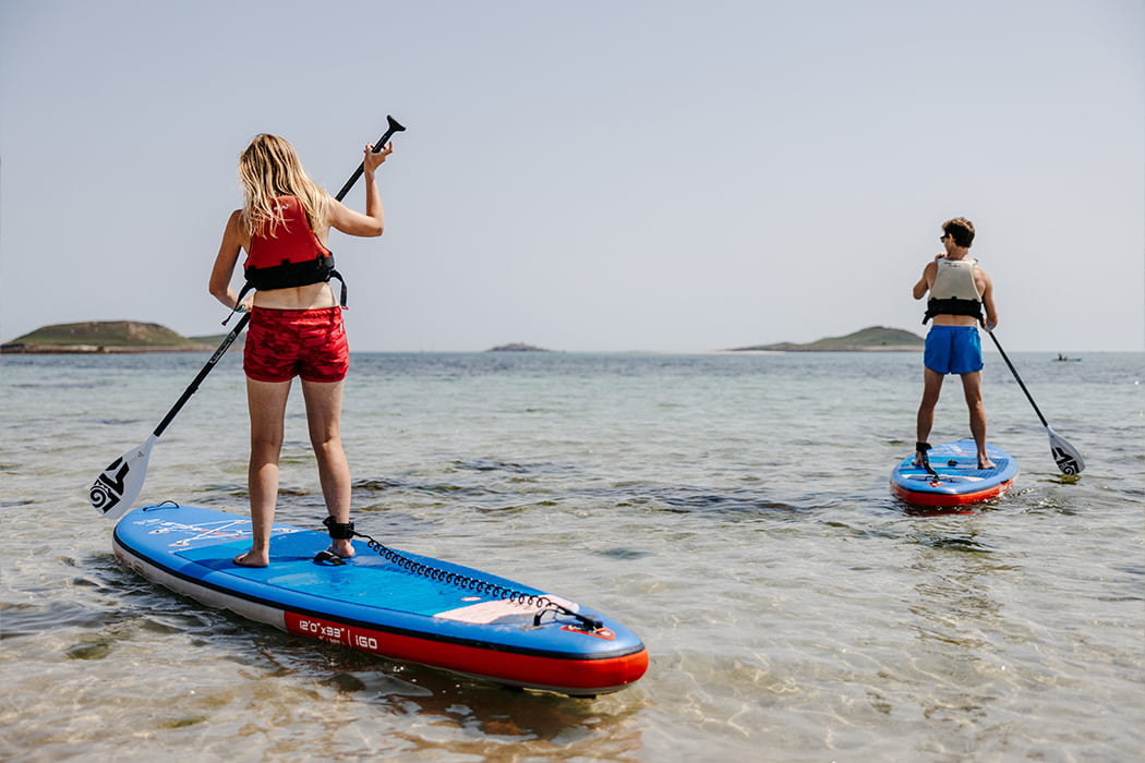 couple paddleboarding, par beach, St Martin's, Isles of Scilly