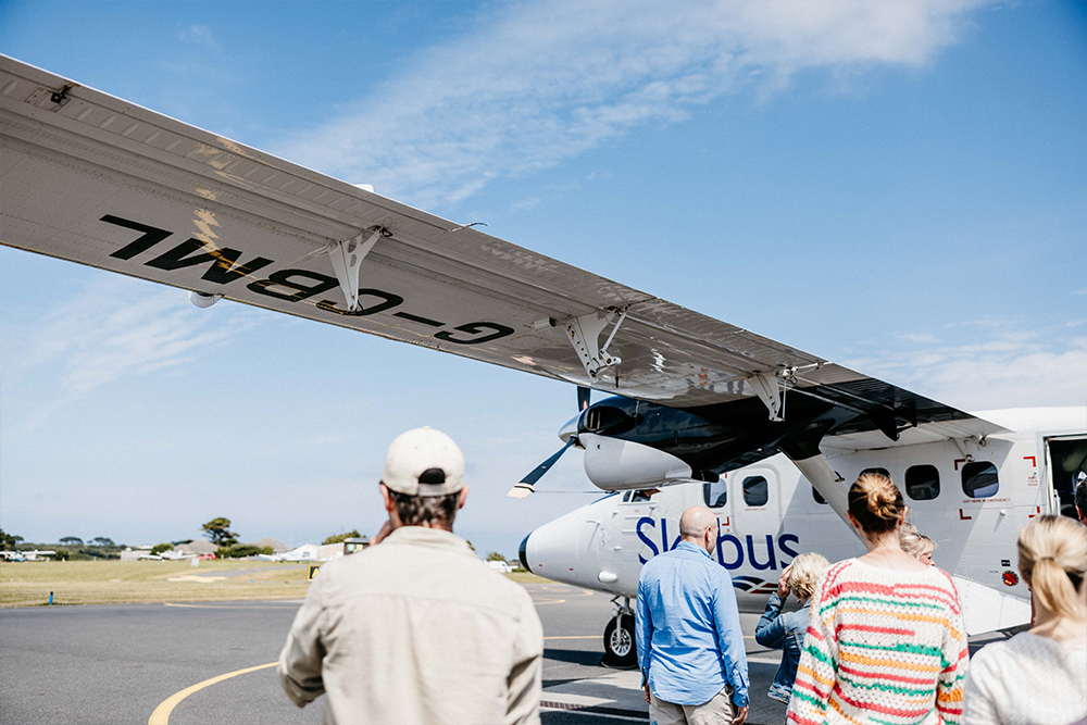 People boarding a Skybus Twin Otter flight at St Mary's Airport, Isles of Scilly