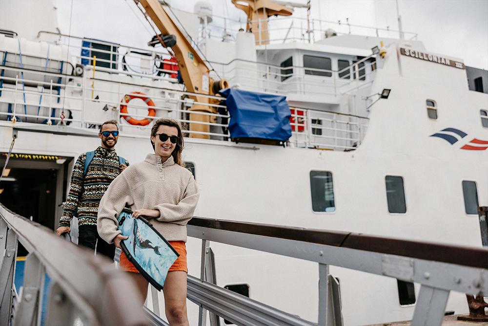 Couple disembarking Scillonian III passenger ferry at St Mary's, Isles of Scilly