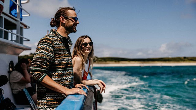 Couple enjoying a boat trip in the Isles of Scilly