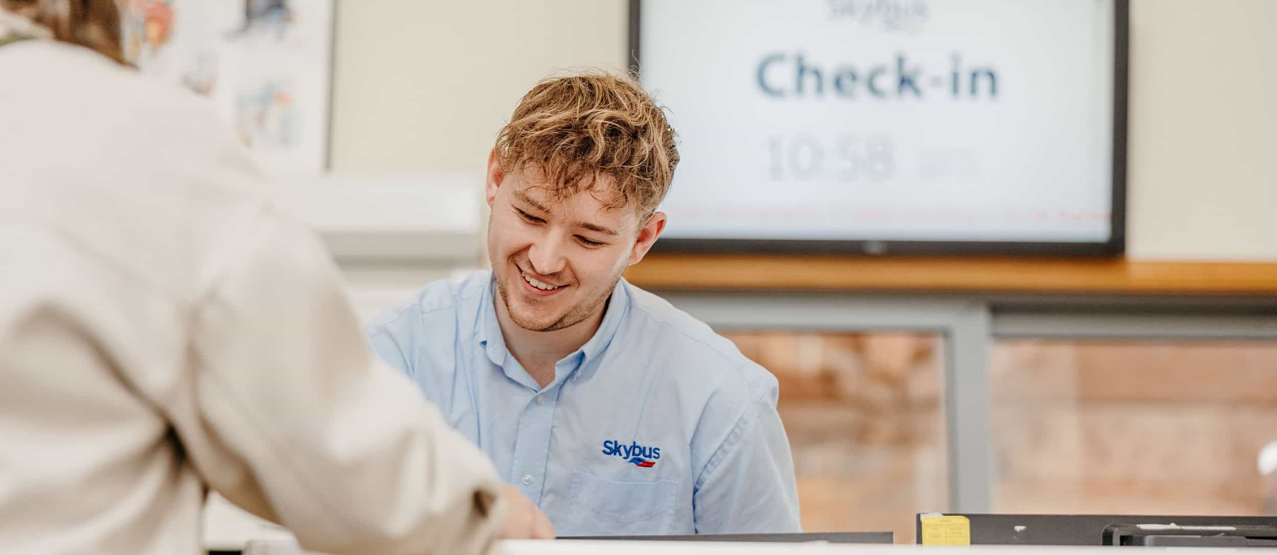 passenger checking in for skybus flight at land's end airport