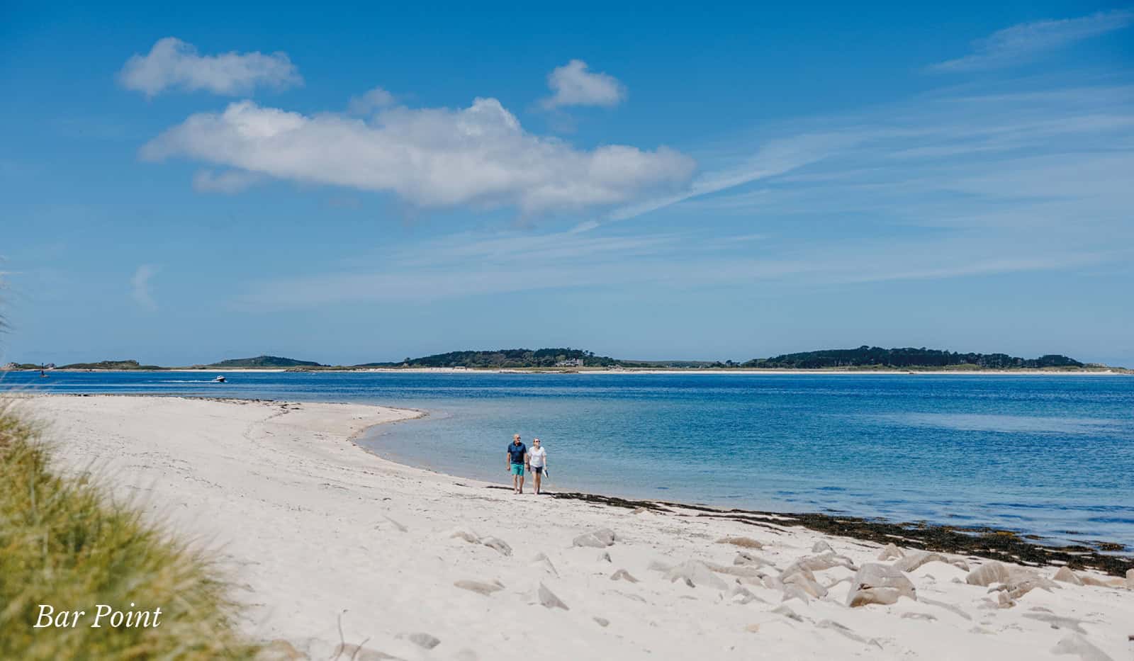 Couple walking along the beach at Bar Point, St Mary's - Isles of Scilly