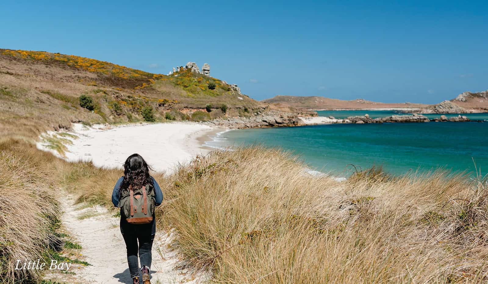 Person walking through the dunes at Little Bay, St Martin's - Isles of Scilly