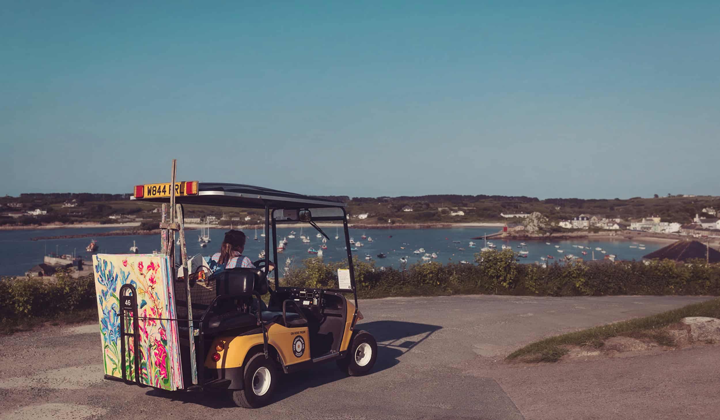 Artist Emily Powell, with her work on a Scilly cart touring St Mary's Isles of Scilly