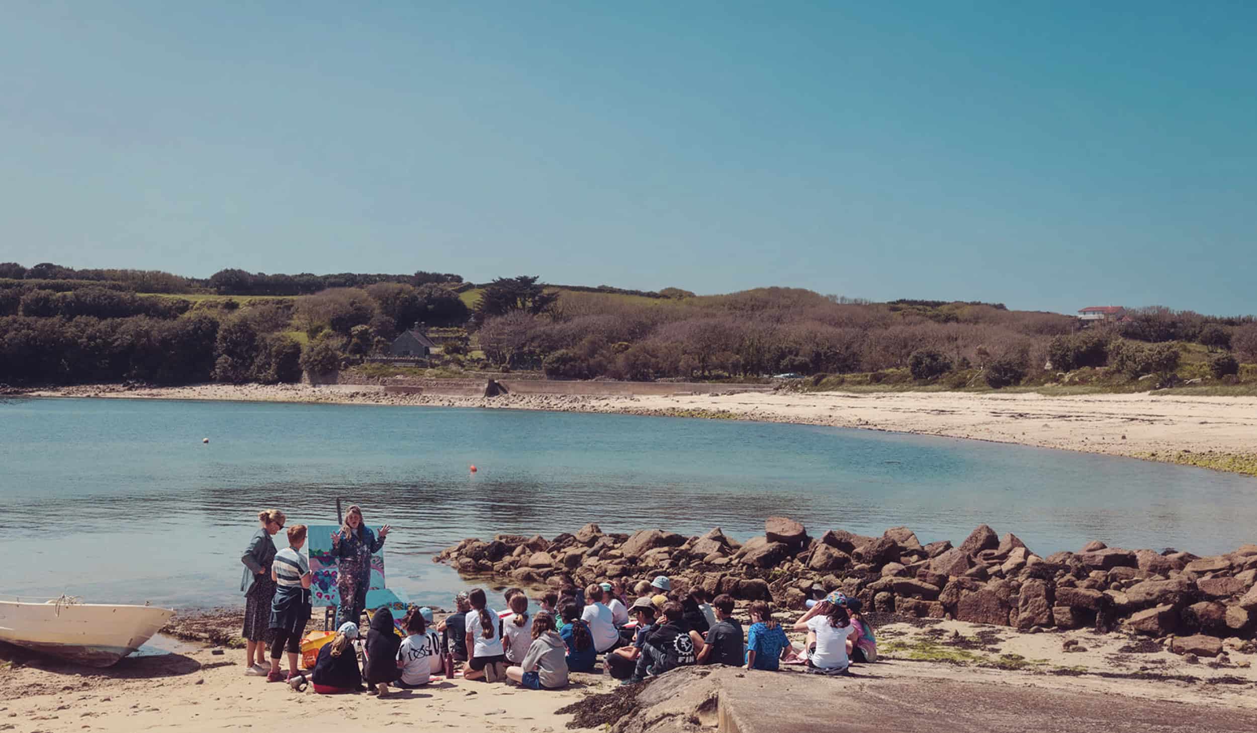 artist Emily Powell with children for a creative workshop on Old Town Beach, St Mary's