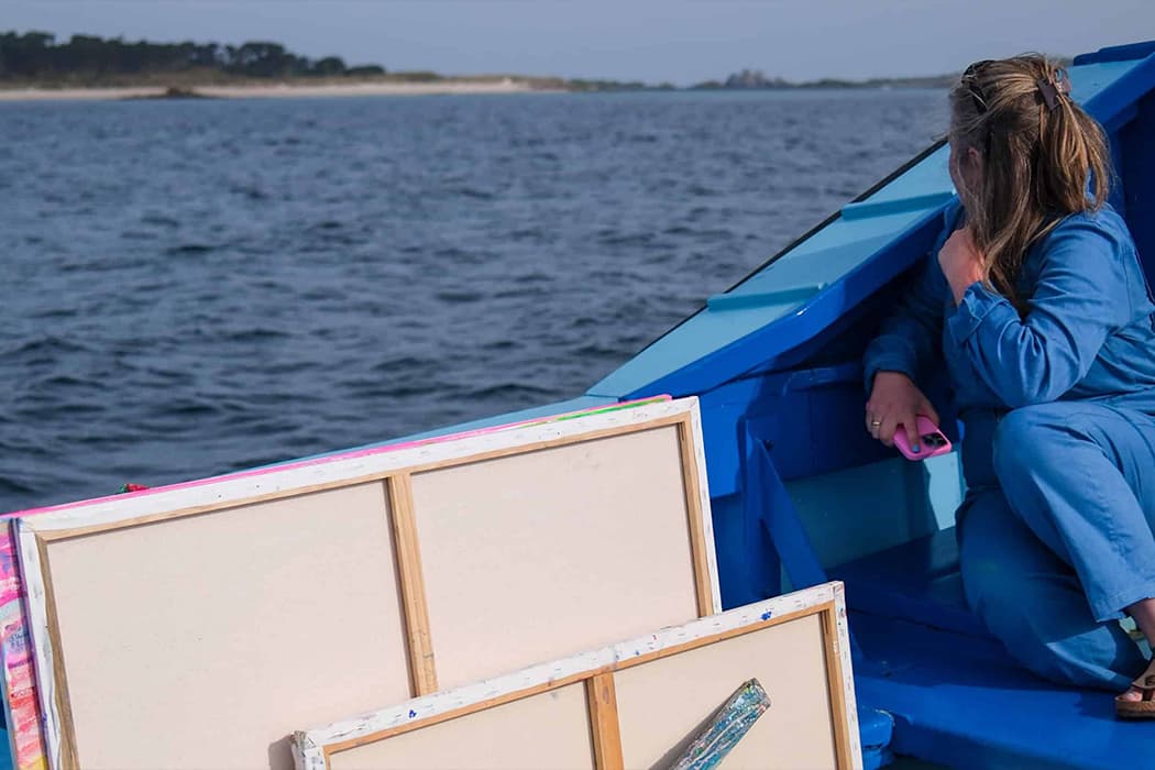 Emily Powell on a tripper boat with her artwork