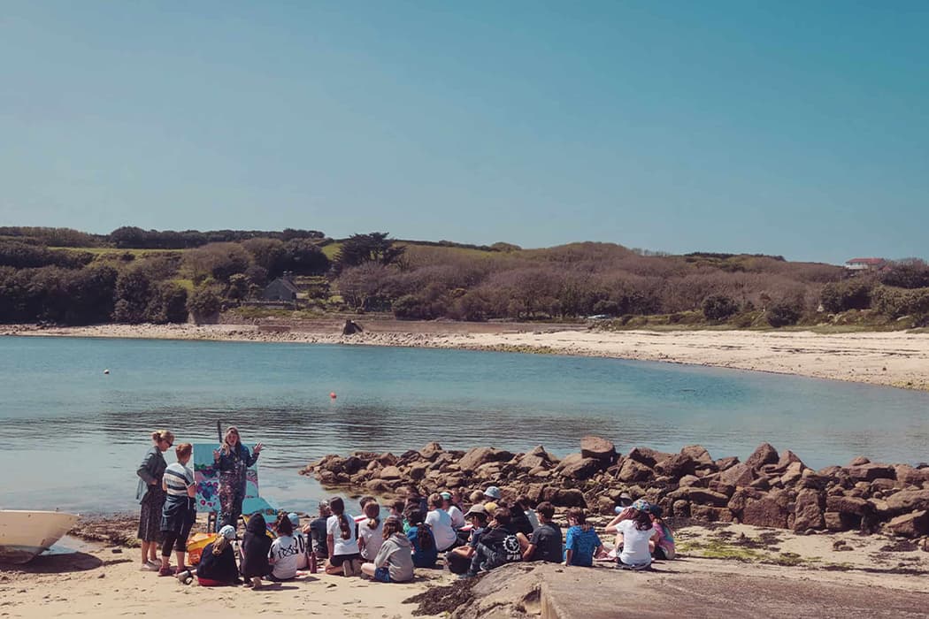 Emily Powell with students from Five Island Academy on Old Town beach, St Mary's