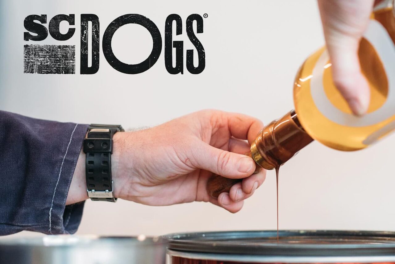 person creating the wax bottle cap for SC Dogs rum