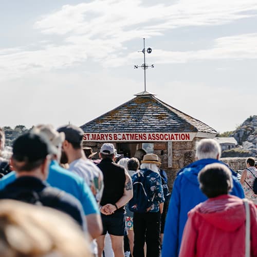 A queue of people getting their boat tickets on St Mary's Quay, Isles of Scilly