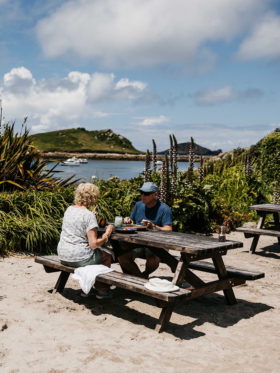 couple eating outisde at Karmer St Martin's, Isles of Scilly