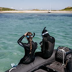 Couple getting ready to snorkel, St Martin's, Isles of Scilly