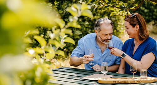 Couple wine tasting a St Martin's Vineyard - Isles of Scilly