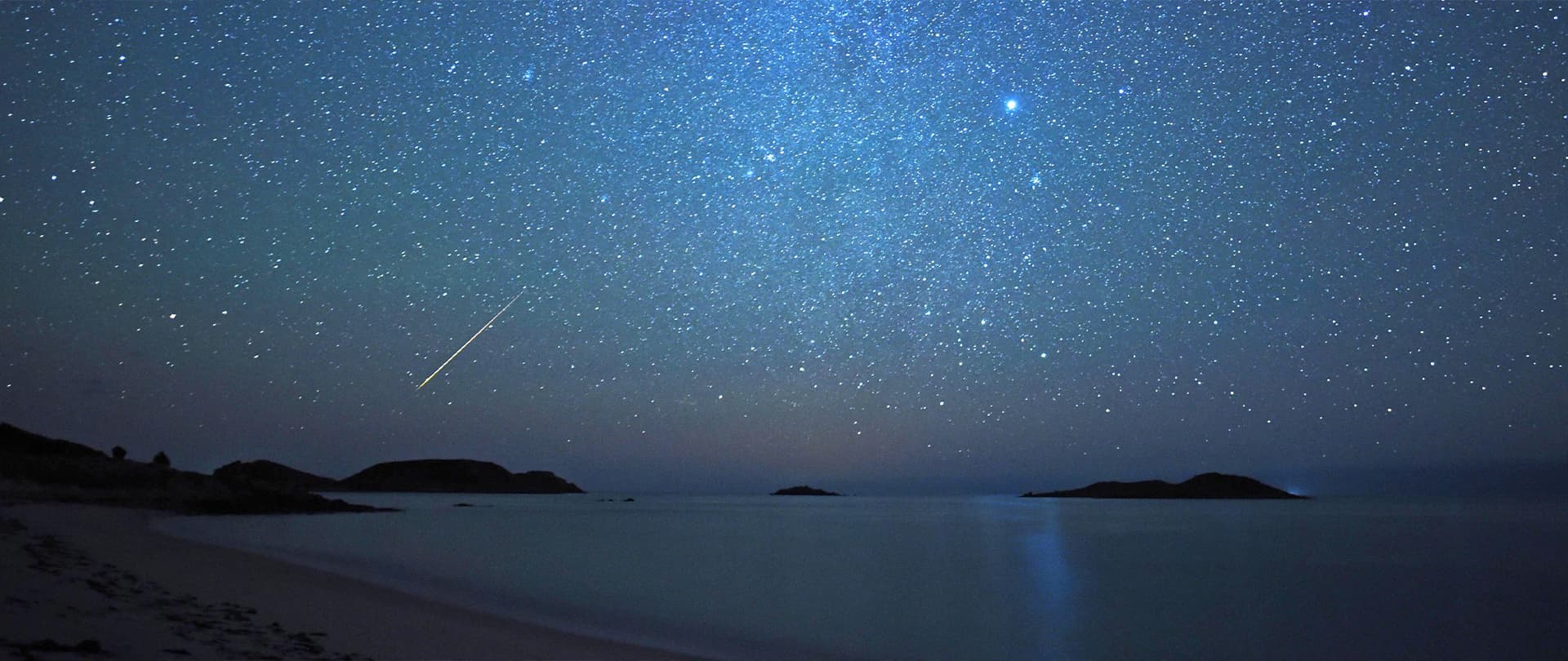 Bruce Frank - night sky with meteors over the Eastern Isles, St Martin's, Isles of Scilly