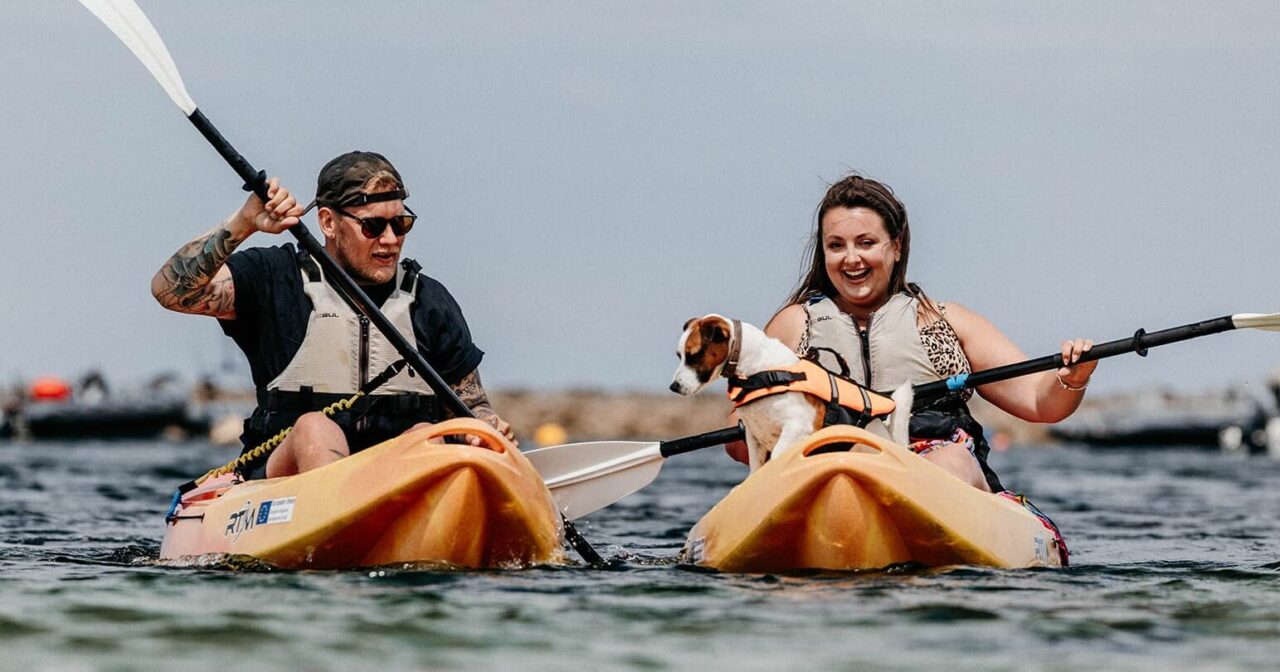 Couple kayaking with their dog, St Agnes, Isles of Scilly