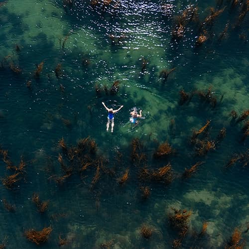 Two women wild swimming, St Mary's, Isles of Scilly